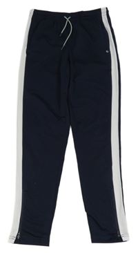 Tmavomodré športové tepláky s pruhom TCM