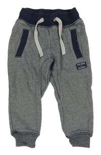 Tmavomodro-biele pruhované tepláky s nápisom H&M