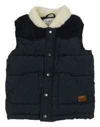 Tmavomodrá prešívaná šusťákovo/manšestrová zateplená vesta s nášivkou Matalan