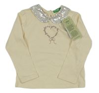 Nové - Smetanové triko s potiskem a límečkem z flitrů Benetton