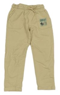 Béžové tepláky s potiskem little kids