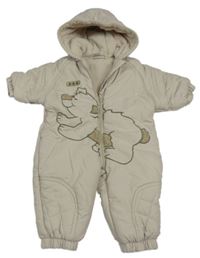 Béžová šušťáková zimná kombinéza s medvěďom a kapucňou