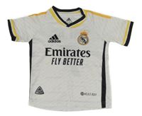 Bílý fotbalový dres s erbem Real Madrid a logem Adidas
